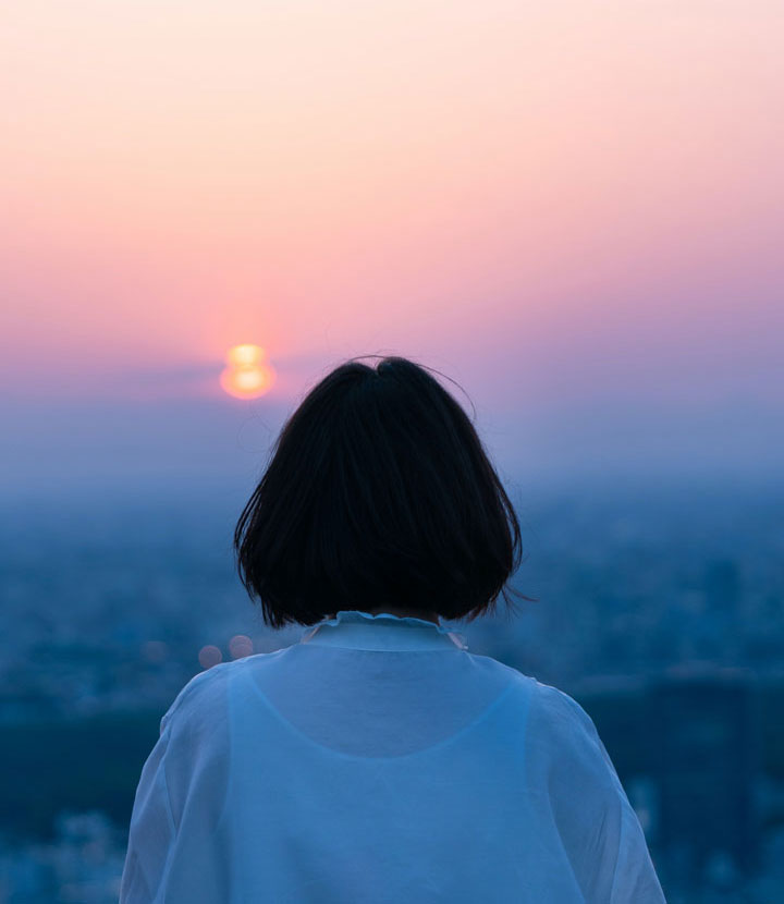 Woman staring at sunset